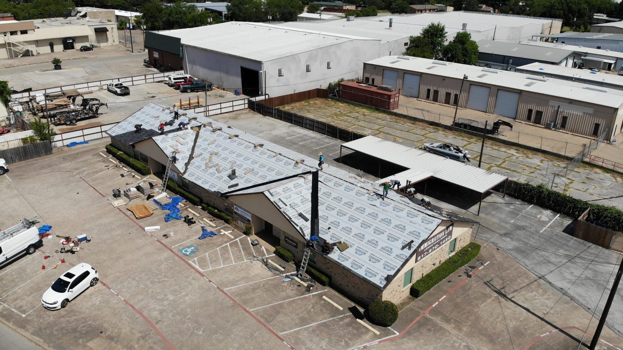 Sloped shingle reroof on a commercial office building, with underlayment across the roof