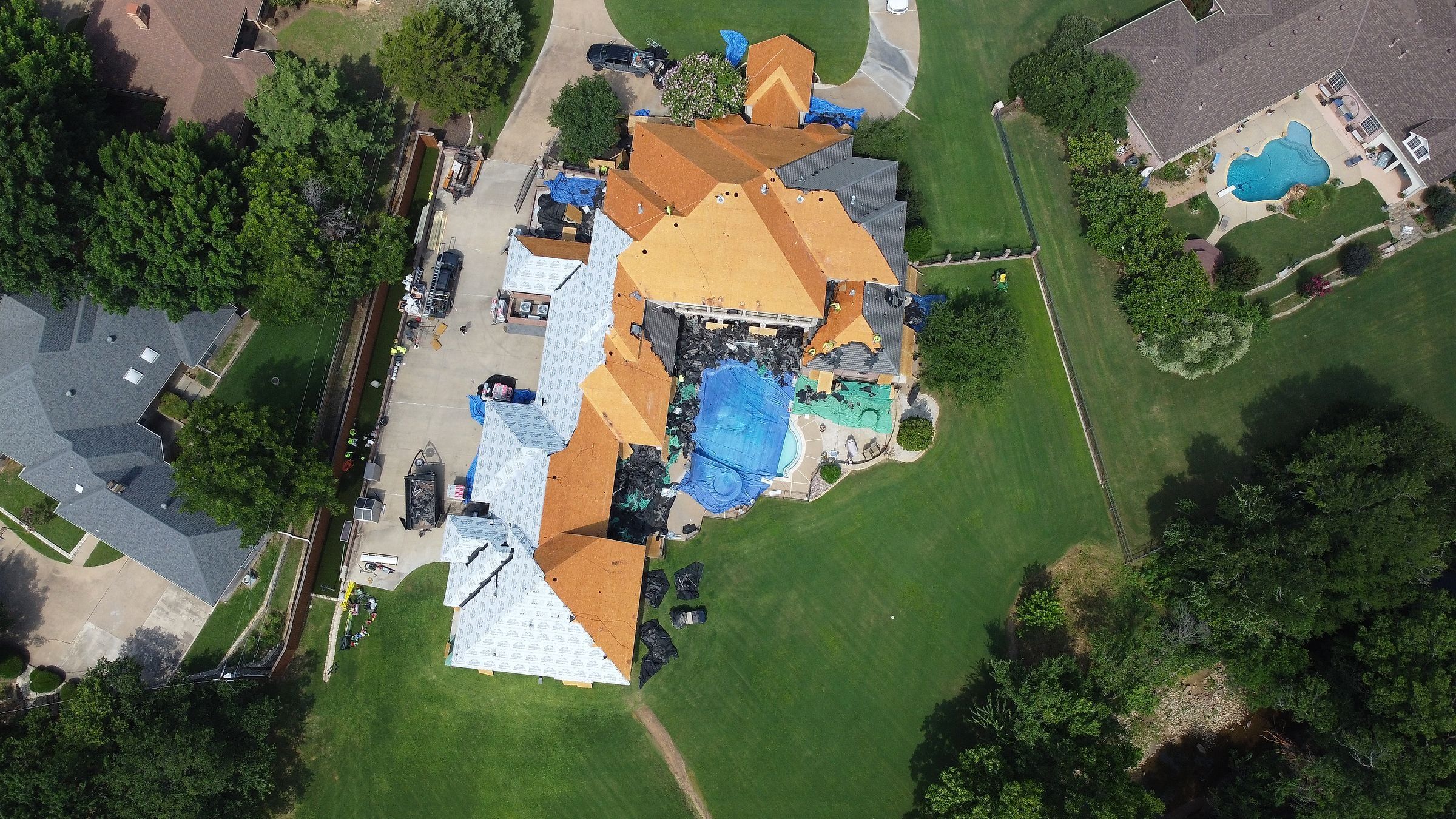 Large home in Arlington, TX mid-replacement with new decking, underlayment and a tarped pool