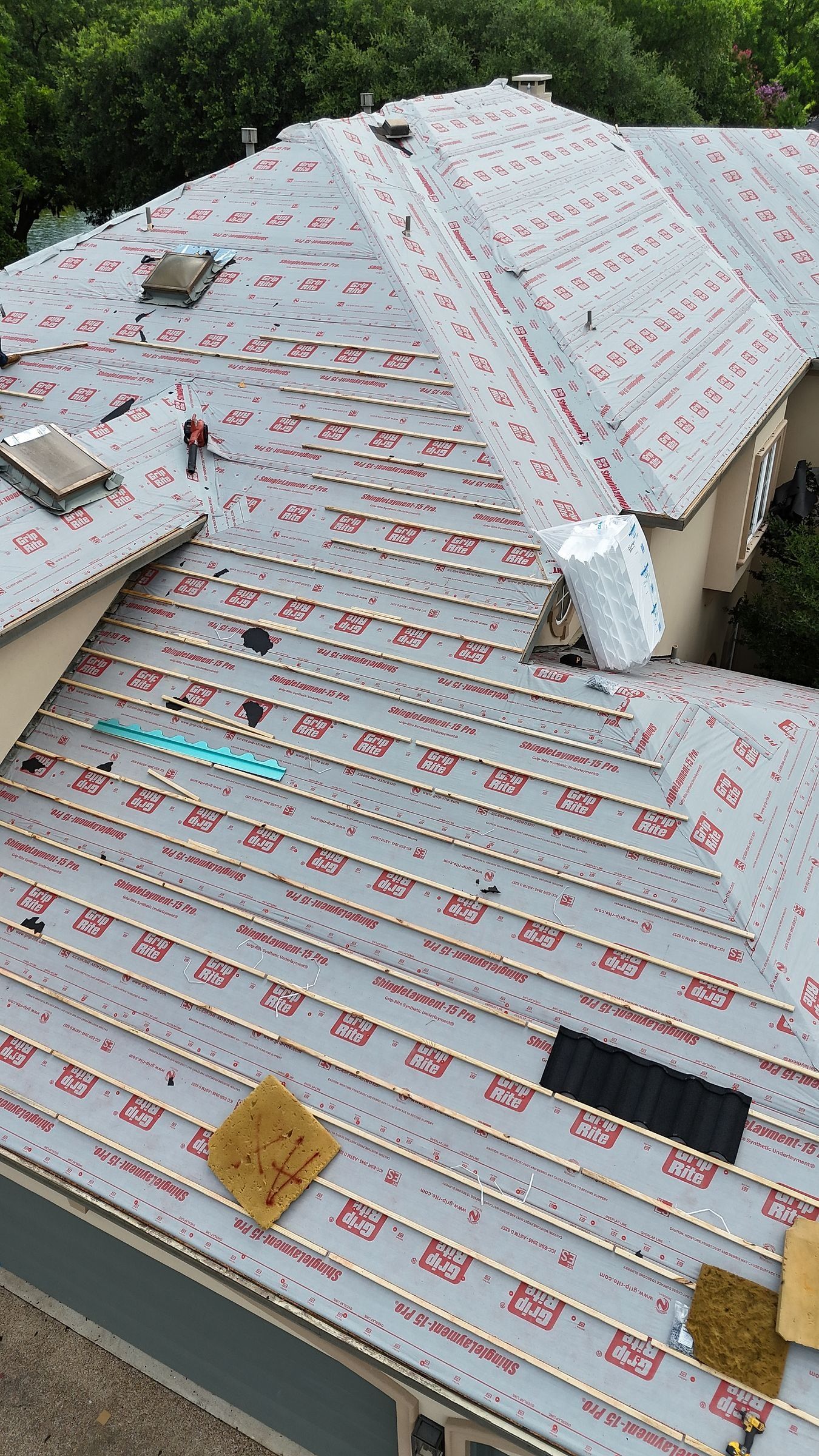Furring strips over synthetic underlayment for a stone-coated steel roof