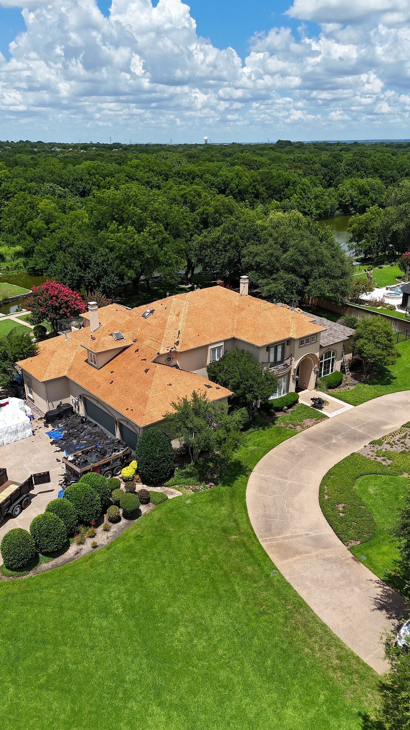 Stucco home with the old shingles removed and the roof deck exposed