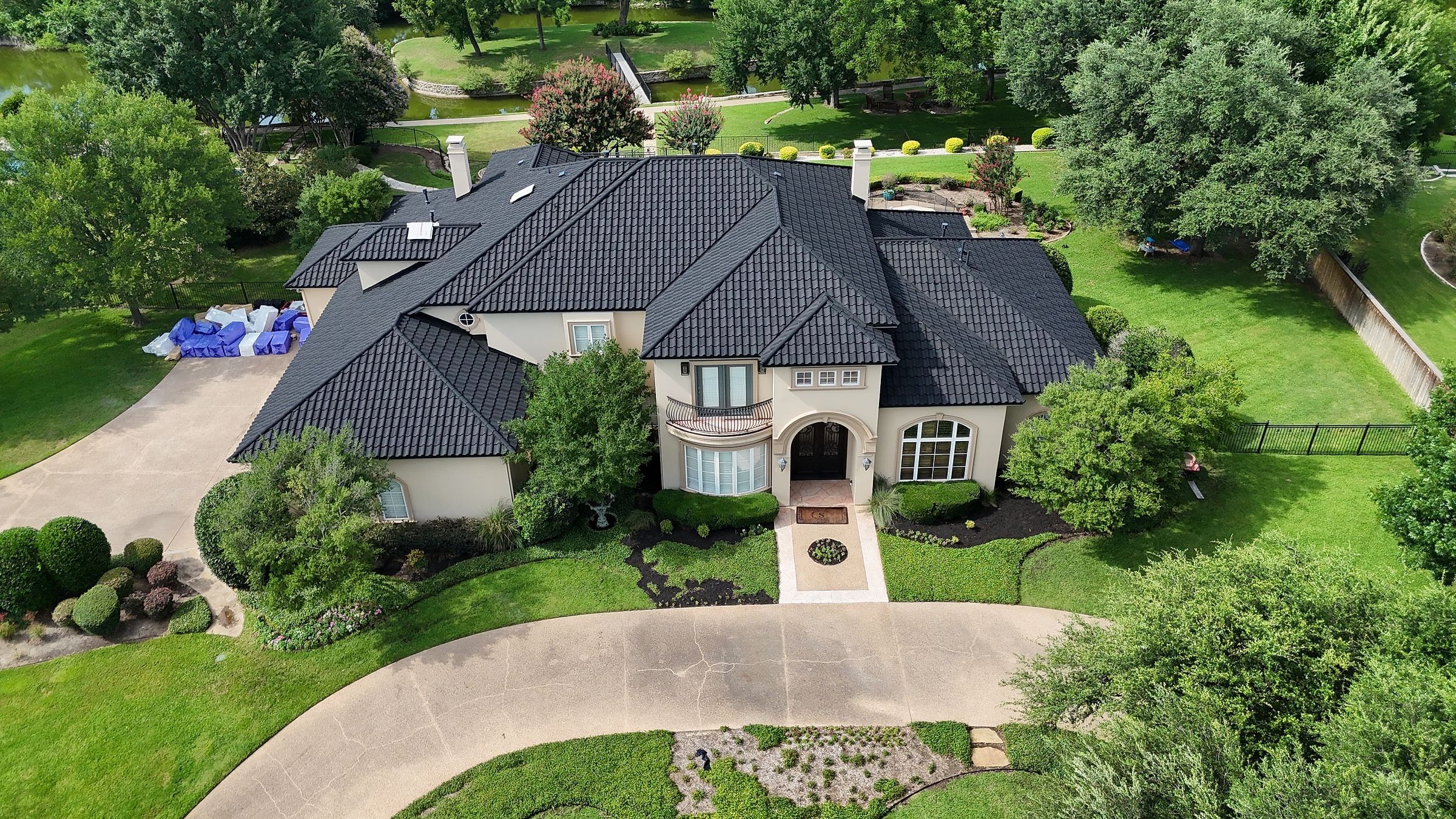 Front of a stucco home with a new black stone-coated steel roof