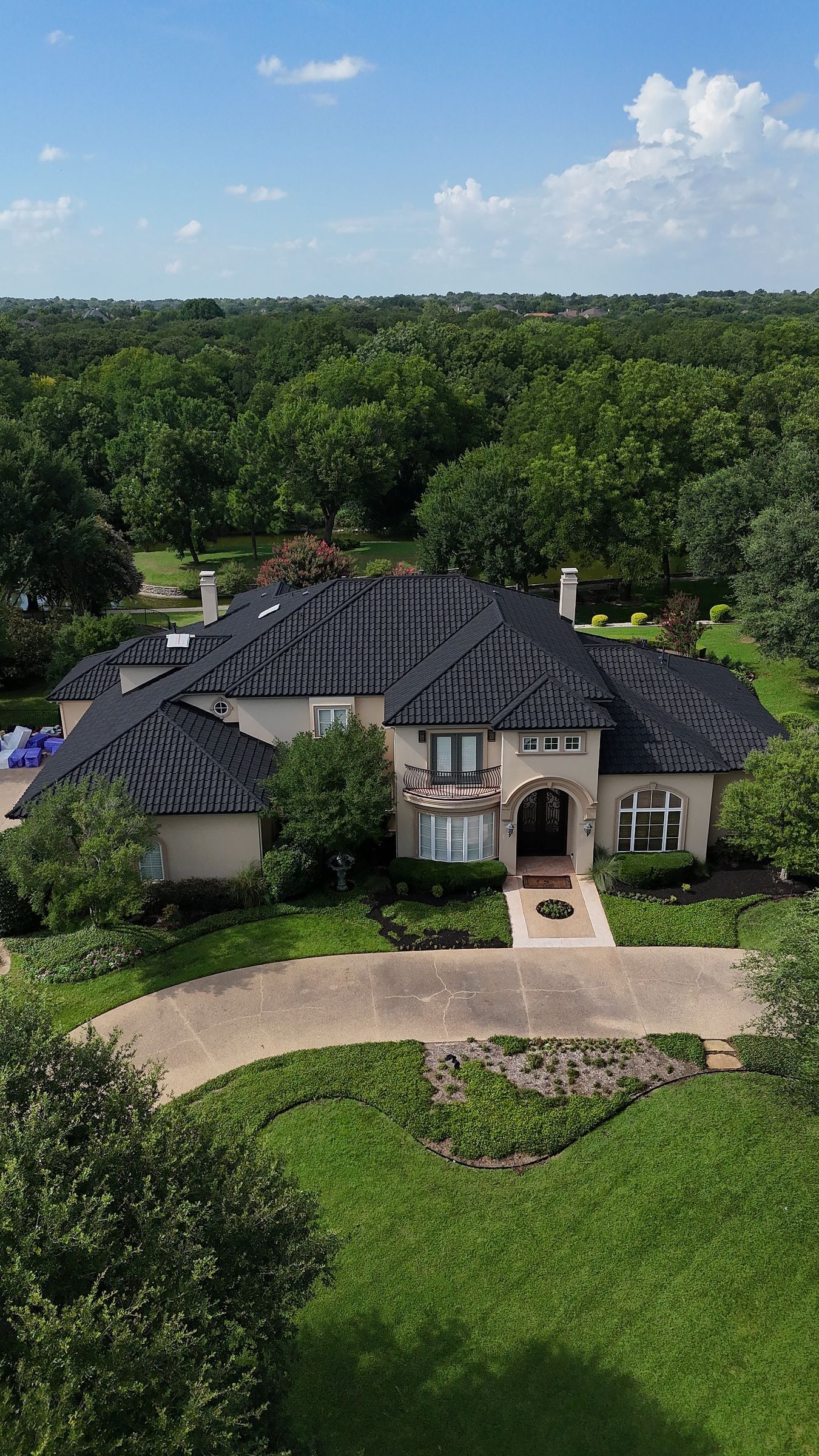Stone-coated steel roof on a stucco home, seen from above