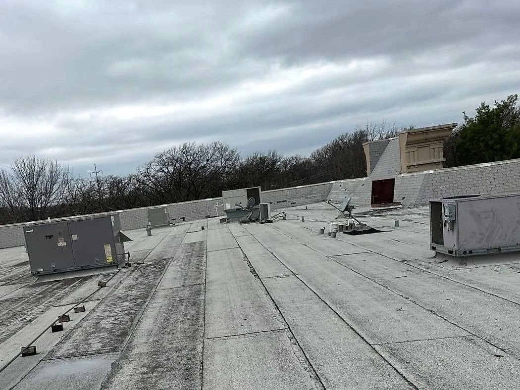 Granulated modified bitumen roof with rooftop HVAC units on a commercial building