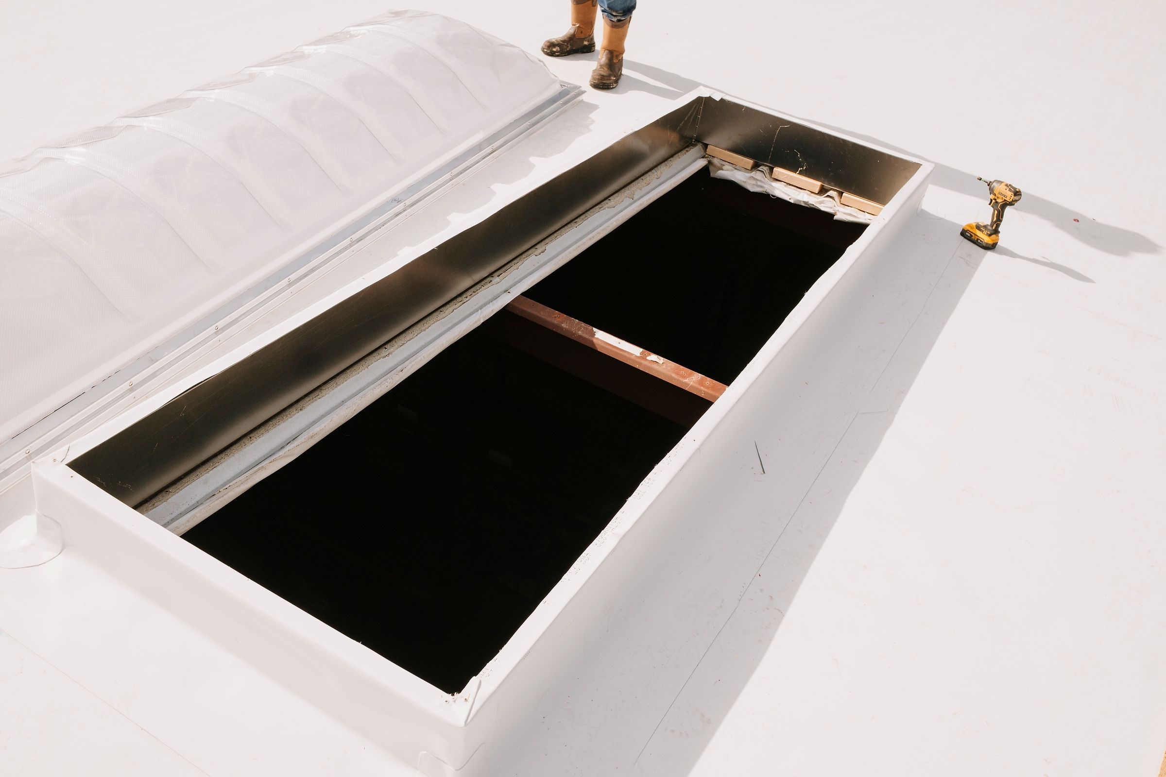 Open skylight curb flashed with white TPO membrane