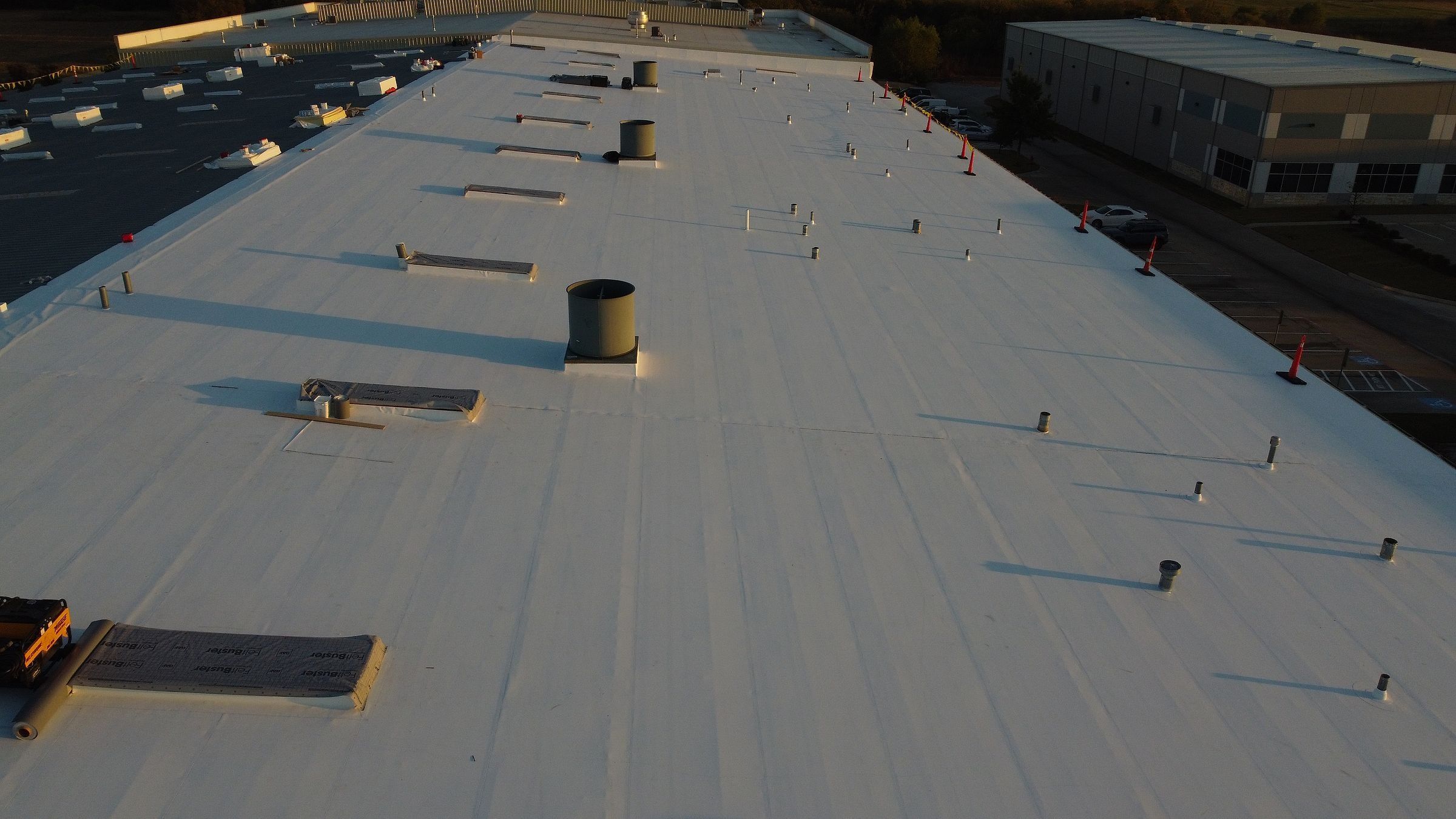 White TPO membrane running the length of a warehouse roof