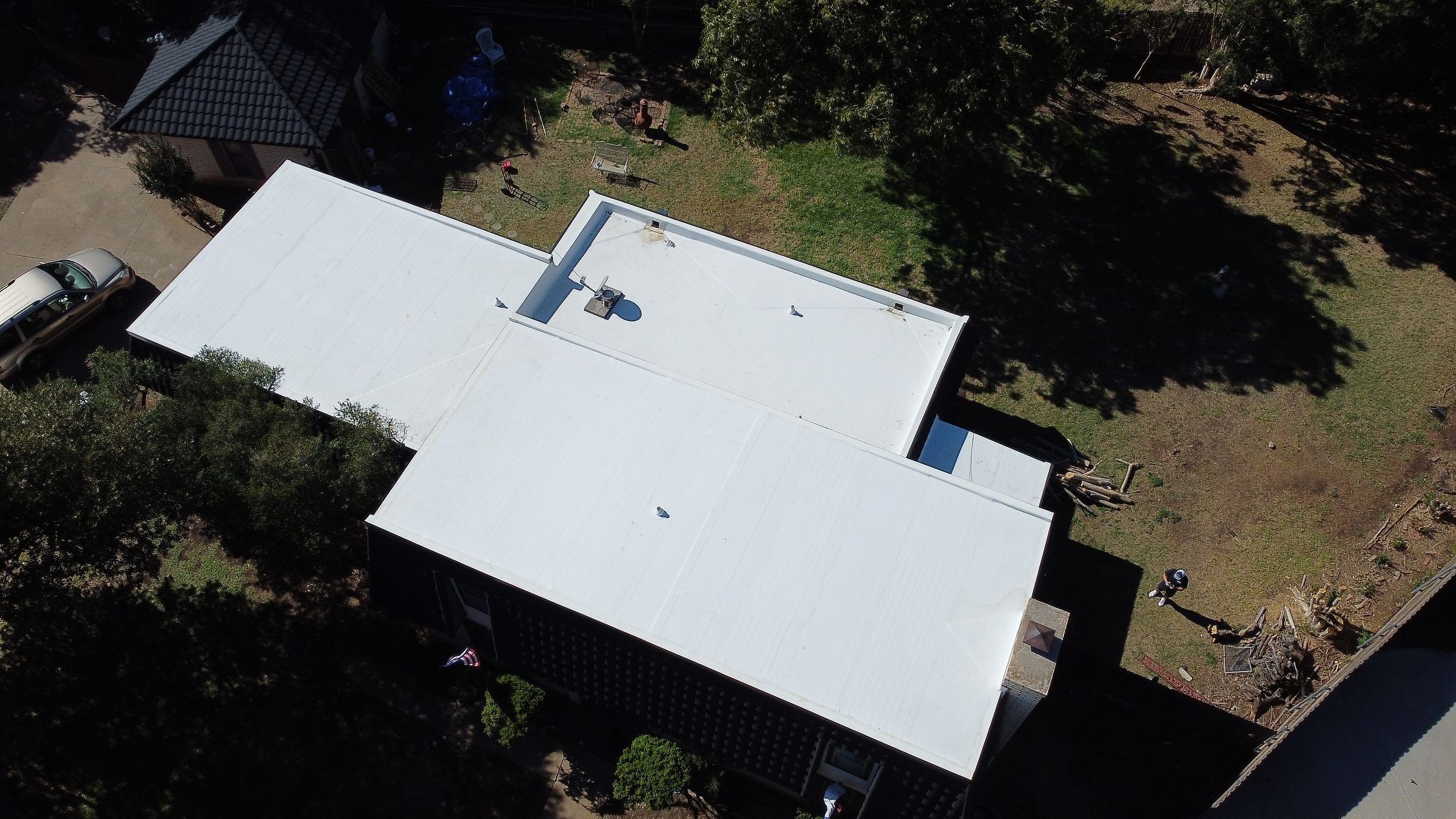 White low-slope roof on a single-story home in Fort Worth, TX, seen from above